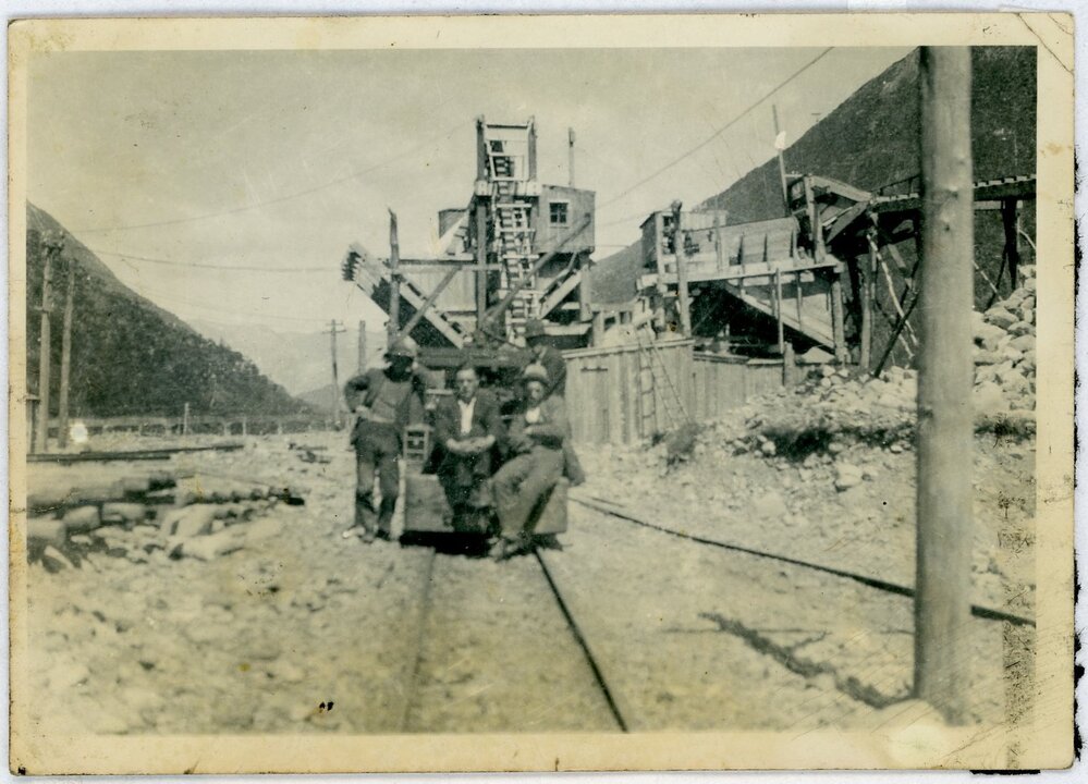 Three men in railway yard