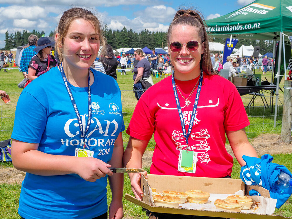 Two women serving Hororāta Pies at the Highland Games