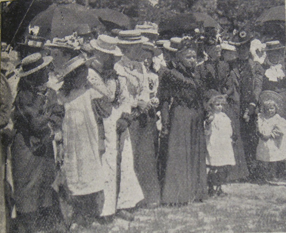 Unfurling the Union Jack flag at Halkett School, some spectators