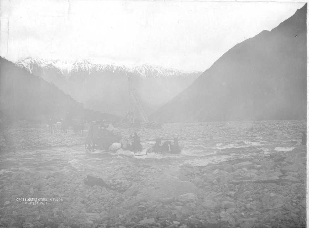 Coaches crossing the Otira River in flood