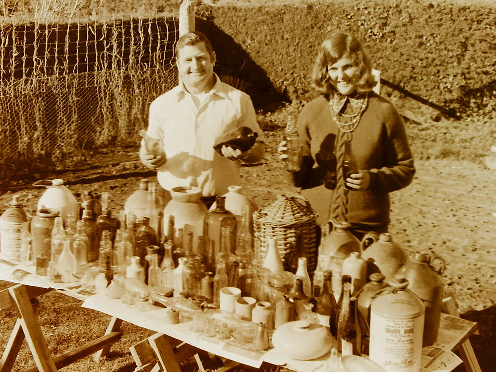 Couple standing with bottle collection