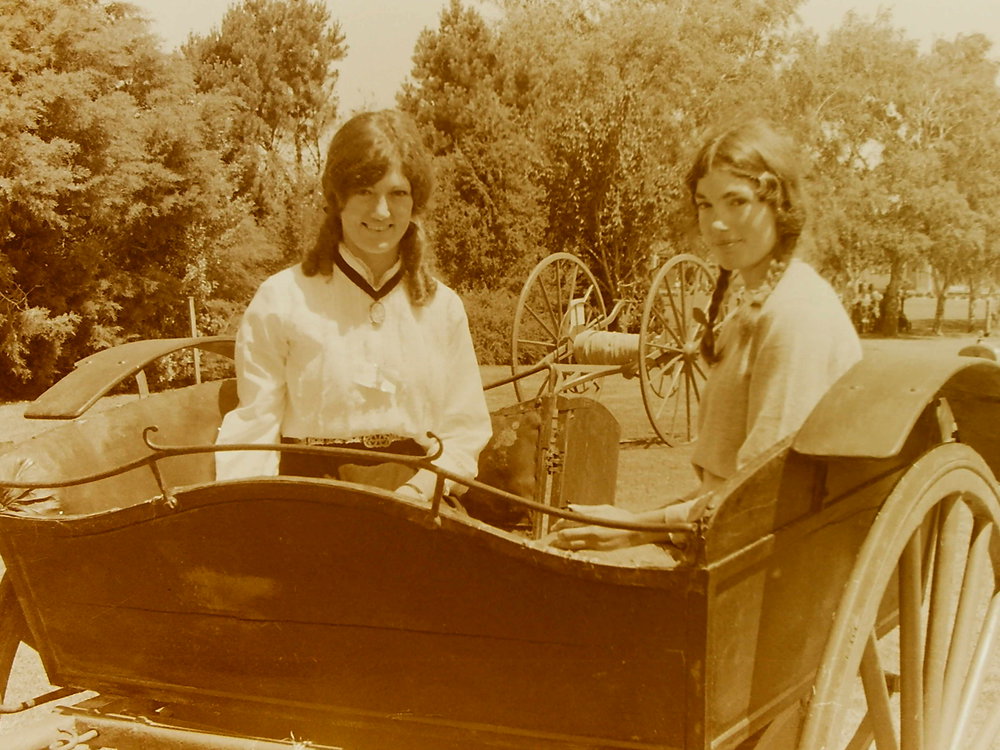 Women in costume in vintage vehicle