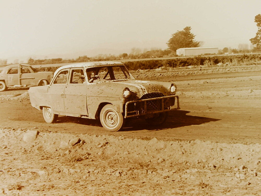 Car racing on dirt race track