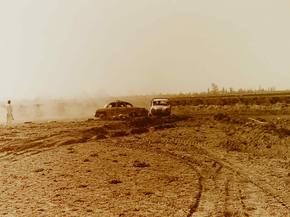 Cars racing on dirt track