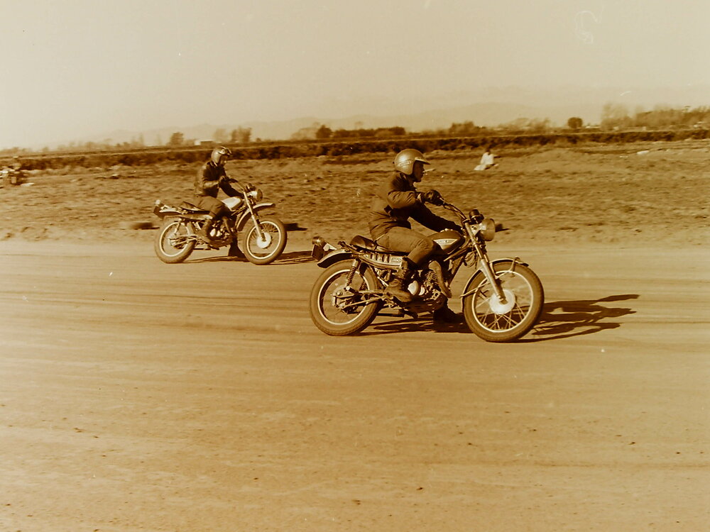 Motorbikes racing on dirt track