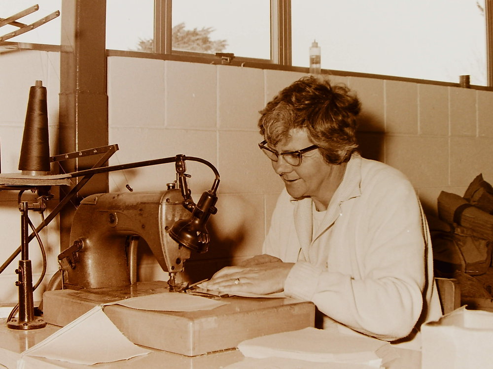 Woman at sewing machine in clothing factory