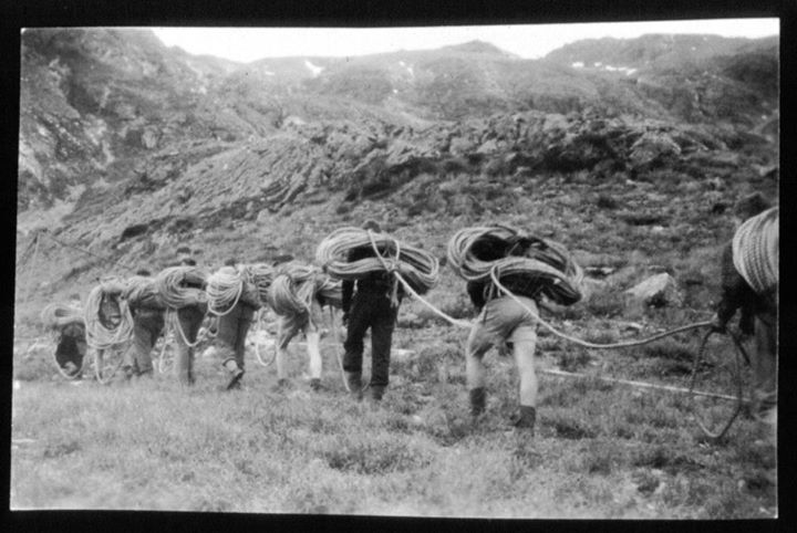Temple Basin volunteers carrying rope up mountain for ski field rope tow