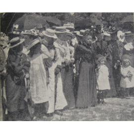 Unfurling the Union Jack flag at Halkett School, some spectators