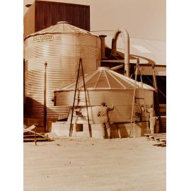 Men building a grain silo