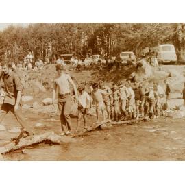 Cub Scouts crossing log bridge