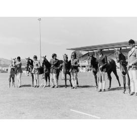 Women and their horses lined up at a horse show