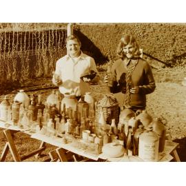 Couple standing with bottle collection