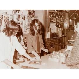 Shop assistants at shop counter
