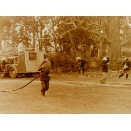 Rolling out the hoses during a fire brigade demonstration 