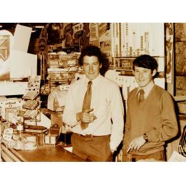 Two men at shop counter in Farmers