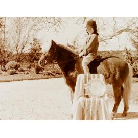 Girl and horse standing with awards