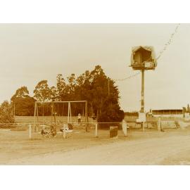 Man in pole-sitting shelter, Leeston Park