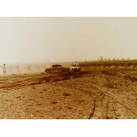 Cars racing on dirt track