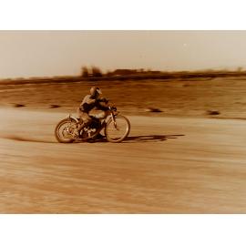 Motorbike racing on dirt track