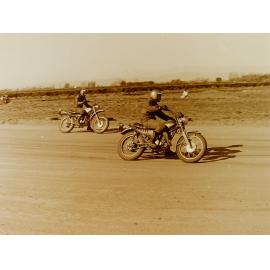 Motorbikes racing on dirt track