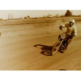 Motorbike racing on dirt track