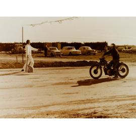 Motorbike at finish line on dirt race track