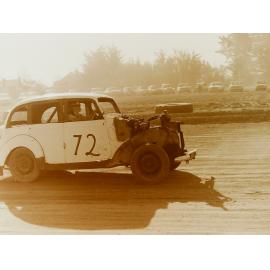 Car racing on dirt race track