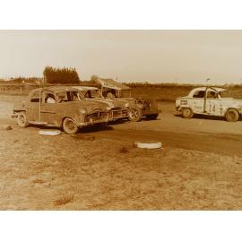 Cars lined up on dirt race track