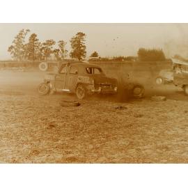 Car with tyres off on dirt race track