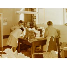 Women sorting clothes at clothing factory