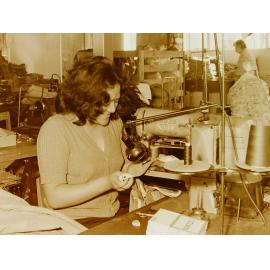 Woman at sewing machine in clothing factory