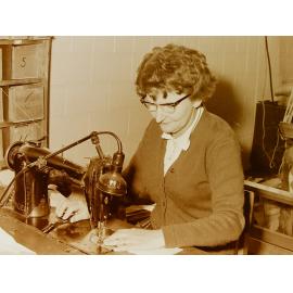 Woman at sewing machine in clothing factory