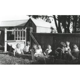 Coe and Rennie children in sandpit