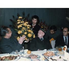 Flowers being presented to Rewi Alley at a banquet held to celebrate his 90th birthday, 1986.