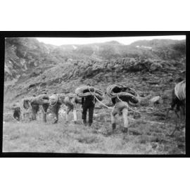 Temple Basin volunteers carrying rope up mountain for ski field rope tow