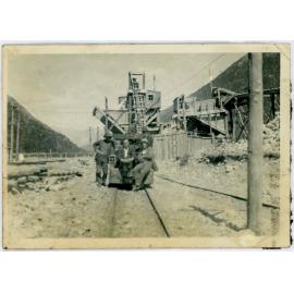 Three men in railway yard