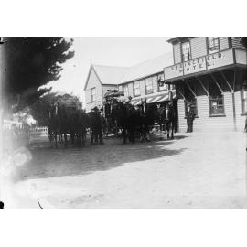 Two horse drawn carriages in front of the Springfield Hotel