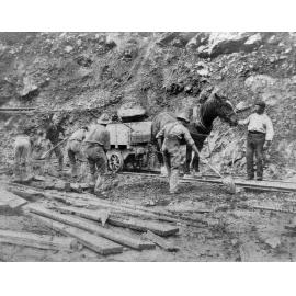 Workmen clearing surface rock