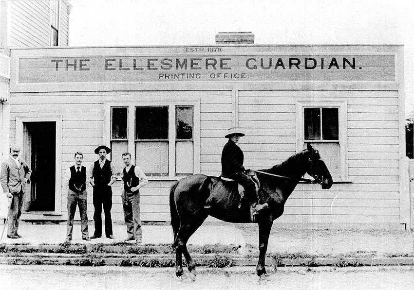 The offices of Ellesmere Guardian in Southbridge. Horace McMillan, later the proprietor for almost 40 years from 1908, stands second from left.  
Hocken Library University of Otago, C-M E 4658-21 
Southbridge-090 
