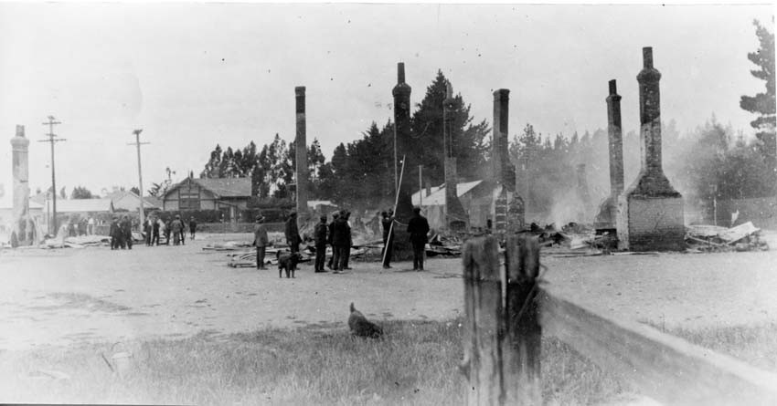 The smouldering remains in 1924 of J. J. Loe's Leeston Hotel & General Store (left) built in 1865. R. Marshall was the licensee at this time.
The Court House is at centre left in this image.  Courtesy of Ellesmere Camera Club
Ellesmere Historical Society EHS-1540